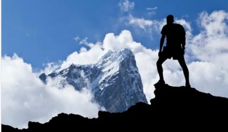 Man standing on the top of of a mountain